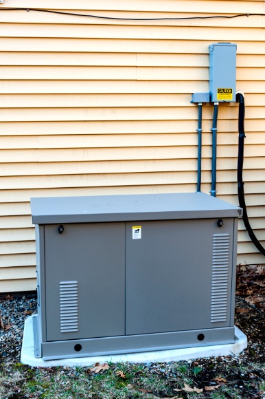 Whole-house standby generator installed beside a home