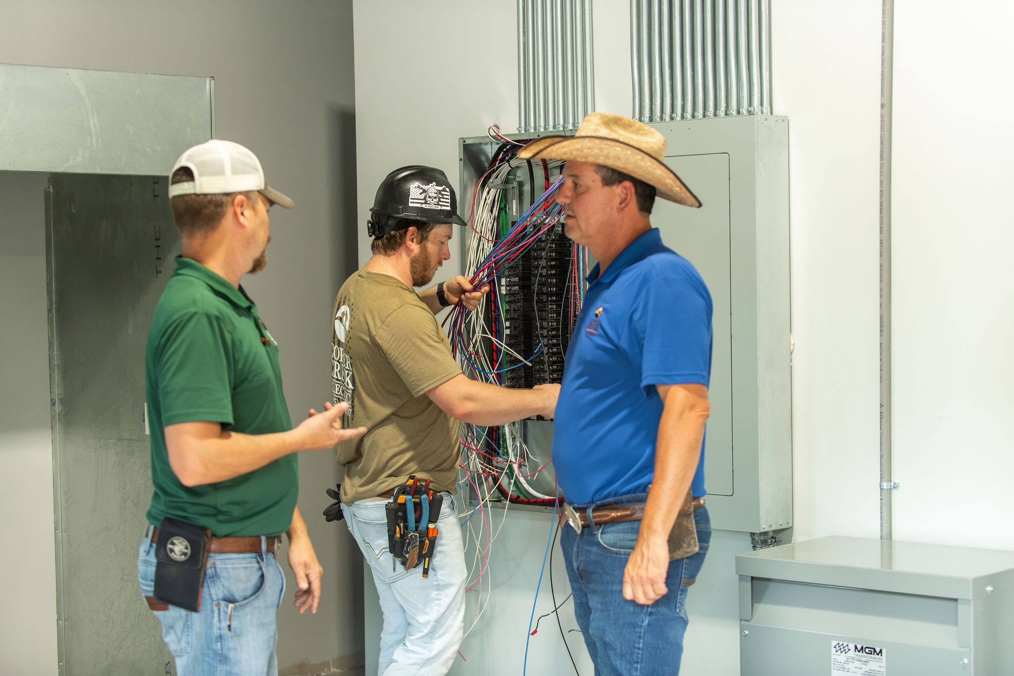 Copper Creek Electric technicians wiring a large commercial electrical panel
