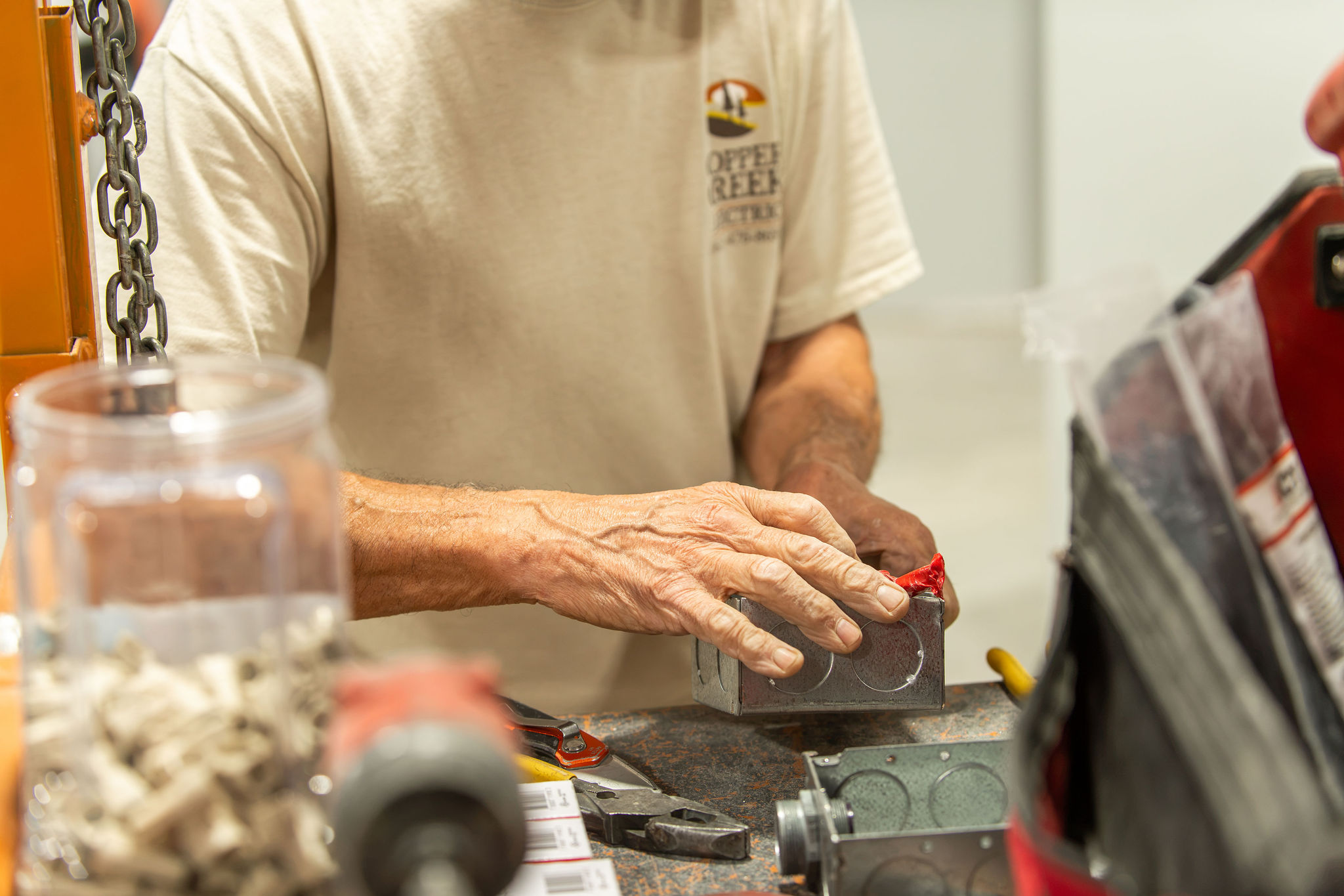 Copper Creek Electric technician assembling an electrical junction box in the shop