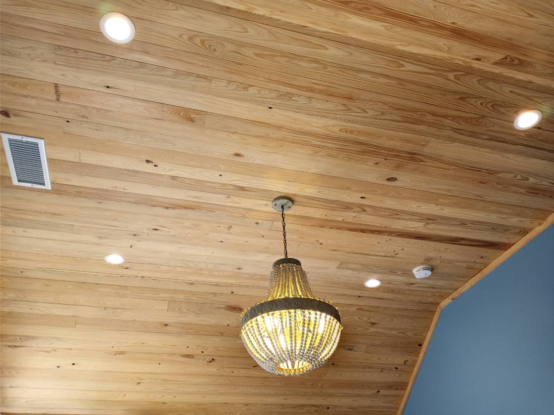Copper Creek Electric, Goodlettsville - finished wood-plank ceiling with recessed lighting and a decorative chandelier